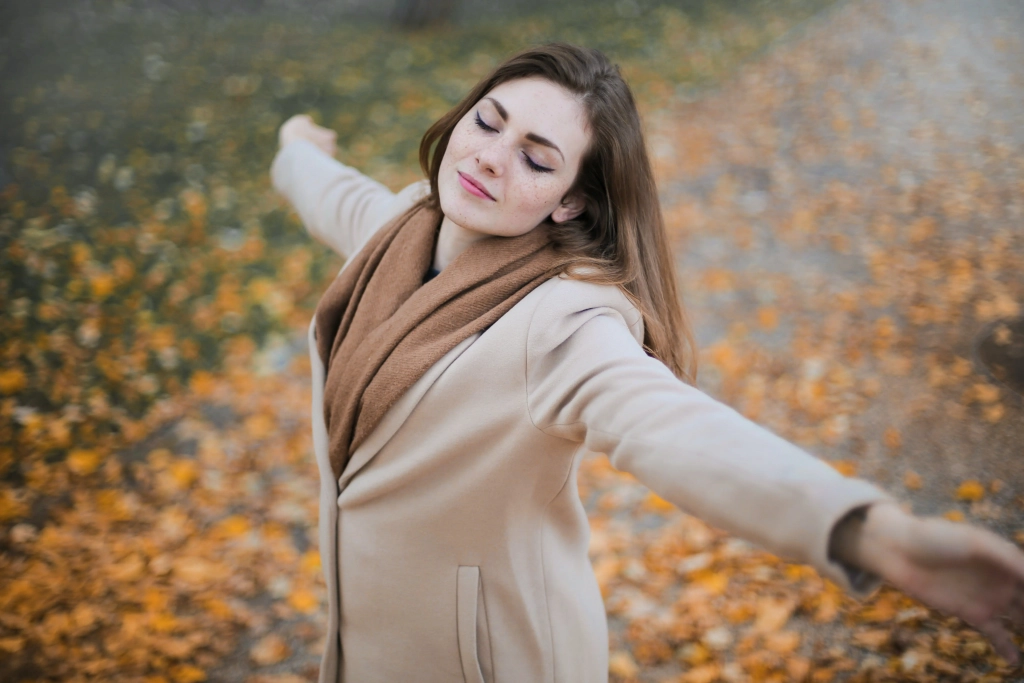 Caucasian woman enjoying peace outdoors on an autumn day in Cochrane & Calgary - Individual Therapy with Najwa Zahr.