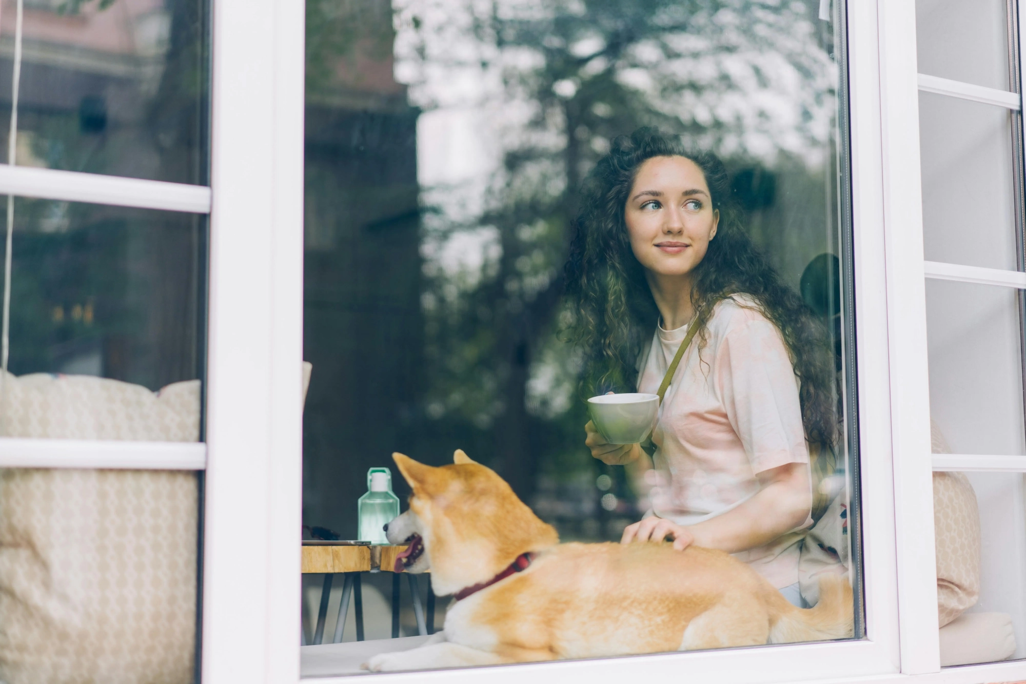 Woman enjoying a peaceful moment with her dog in Calgary, reflecting the comfort of family counselling services.