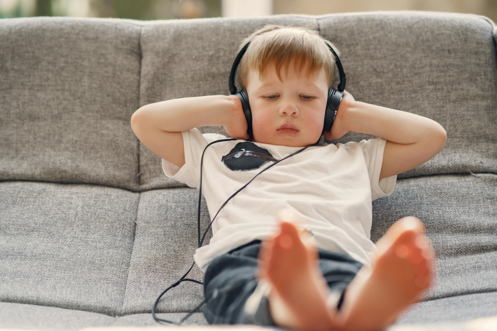 boy alone on couch with headphones