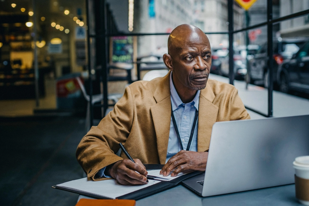 coloured man at desk at office