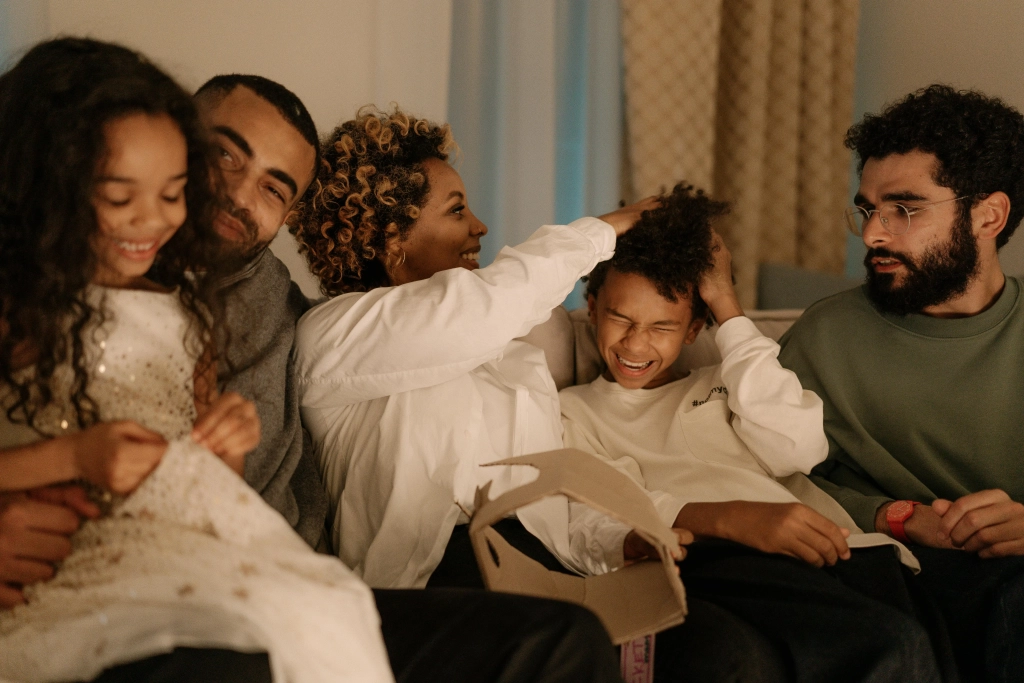 Multi-cultural family enjoying a moment together on a couch in Cochrane & Calgary - CBT with Najwa Zahr.